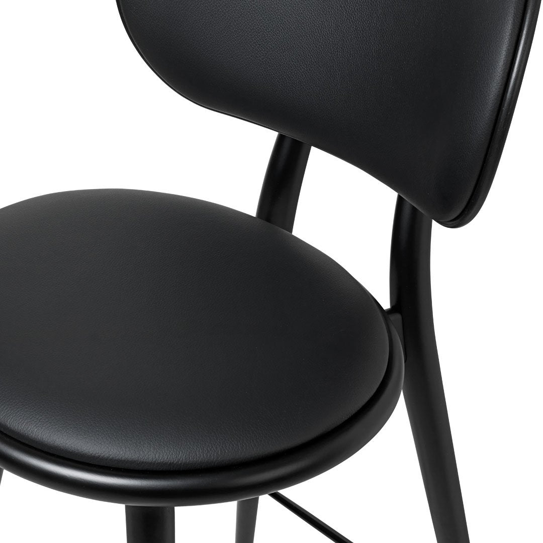 Black sleek chair with smooth curves and a matte finish. Modern design highlights simplicity and elegance.