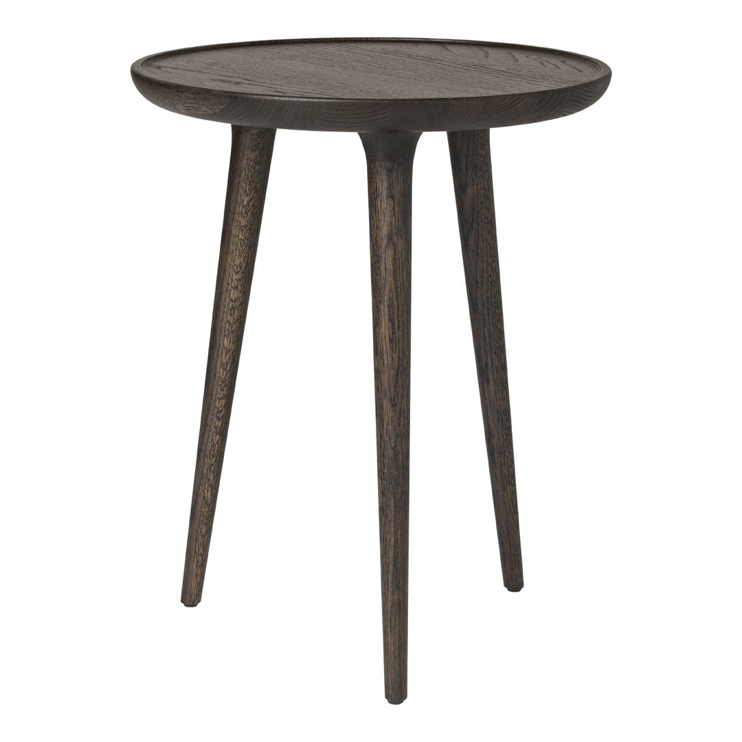 Dark wood round side table with a subtle textured finish and tapered legs. Simple, modern design in earthy tones.