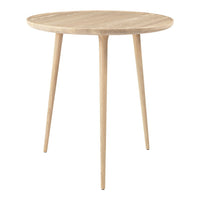Light oak round side table with smooth, natural wood grain and tapered legs. Minimalist design perfect for modern decor.