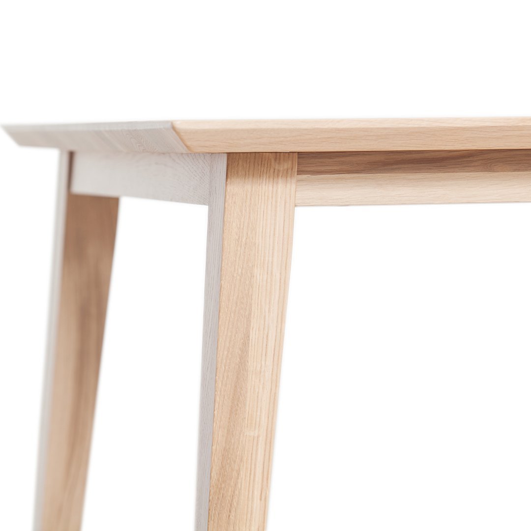 Light wood table with a natural finish and clean lines, featuring a minimalistic design and subtle color variation.