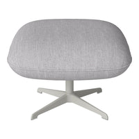 Light gray textured upholstery on a modern ottoman with a minimalist white base. Ideal for contemporary decor.