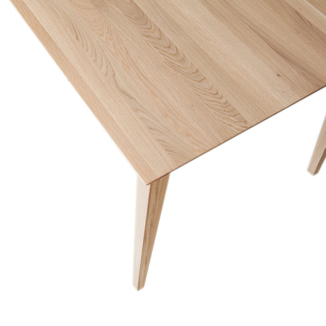 Light oak wood table with natural grain patterns and sleek, minimalist design. Perfect for modern decor.