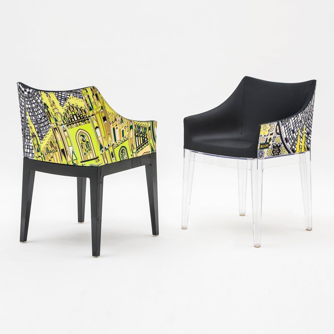 Colorful patterned chair with vibrant yellow and black design, featuring a sleek transparent base. Perfect for modern decor.