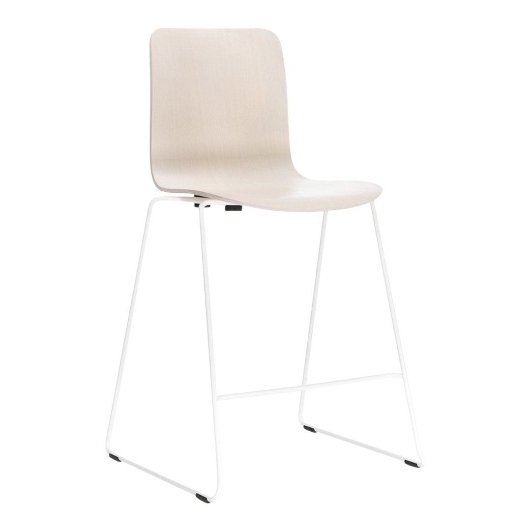 Beige high stool with a minimalist design and sleek white metal legs. Simple and modern decor accessory.
