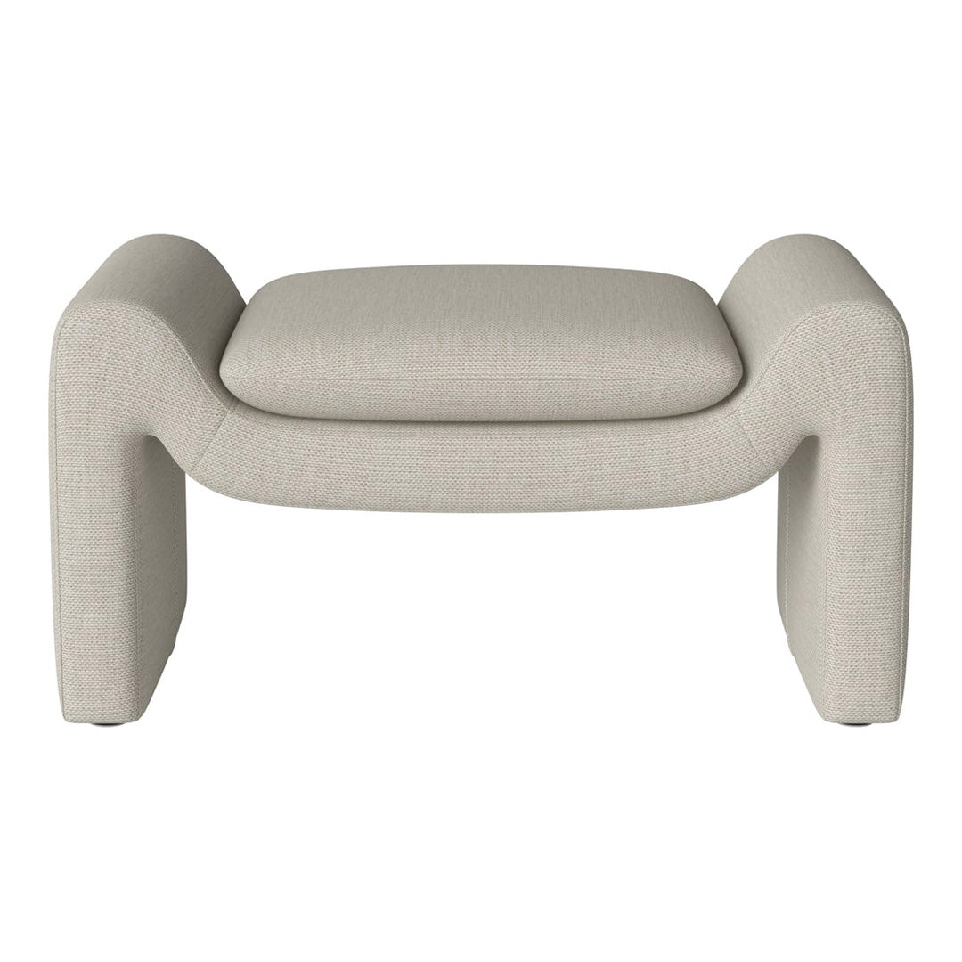 "Modern cream accent stool with a textured fabric finish and minimalist design."