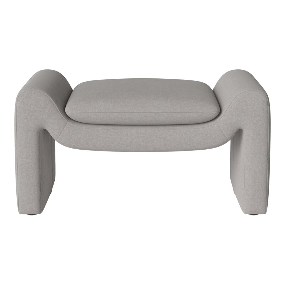 Light gray upholstered ottoman with a smooth, minimalist design and soft, rounded edges. Perfect for modern decor.