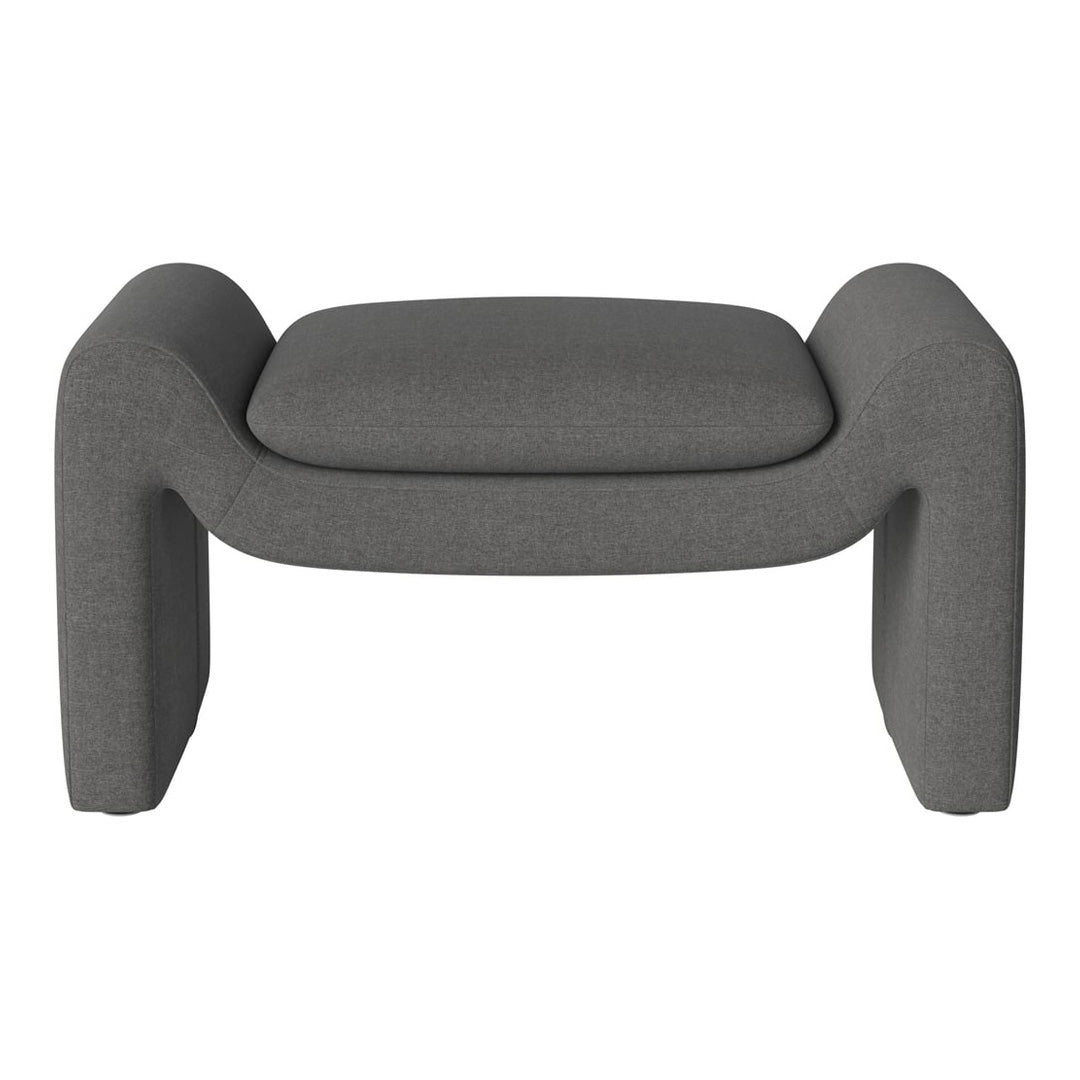 Gray upholstered ottoman with a minimalist design and soft fabric finish, ideal for modern interiors.