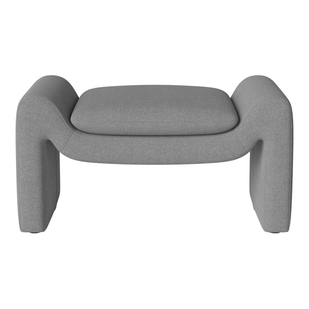 Gray upholstered ottoman with a sleek, minimalist design and smooth, textured fabric. Perfect for modern decor.