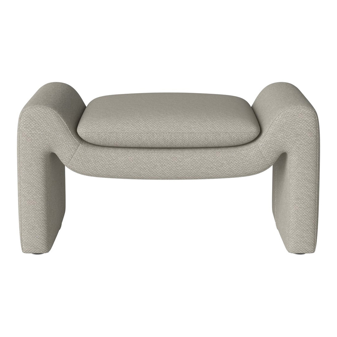 Beige textured ottoman with rounded edges and a minimalist design, perfect for modern home decor.