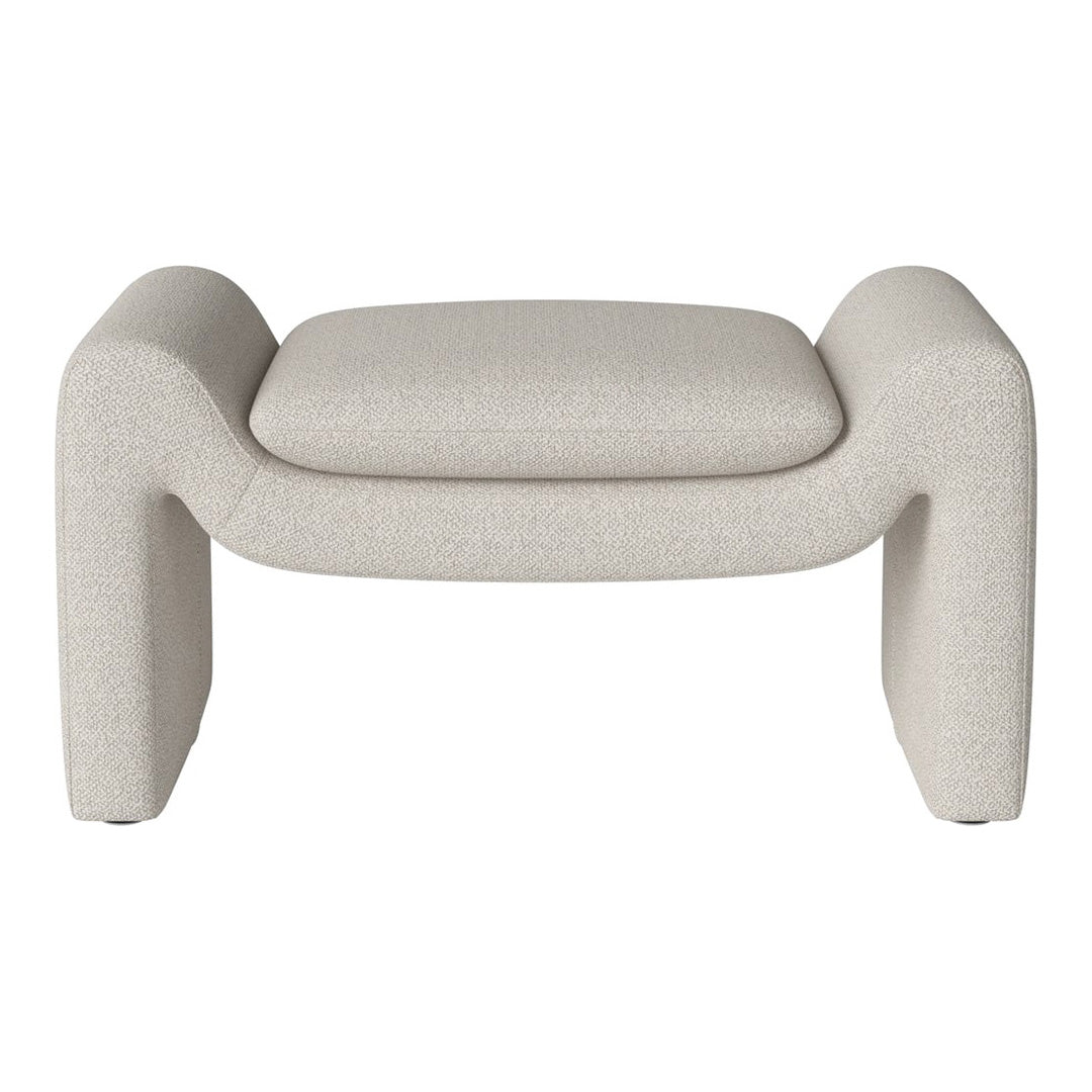 Beige textured ottoman with a minimalist design and curved edges, perfect for modern interiors.