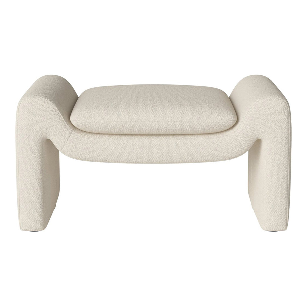 Cream-colored textured ottoman with smooth, rounded edges and a minimalist design. Ideal for modern decor accents.