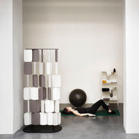 Modern room divider featuring alternating white and gray panels in a geometric pattern on a sleek black base.