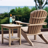 Light beige Adirondack chair with a matching side table, set against a lush green background. Perfect for outdoor relaxation.