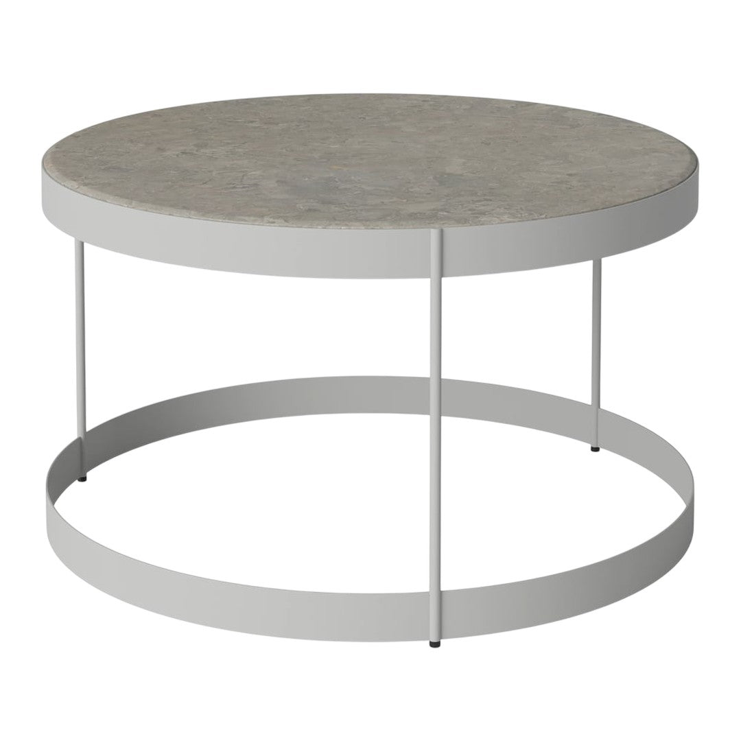 Round coffee table with a smooth gray top and sleek white metal legs, featuring a minimalist design.