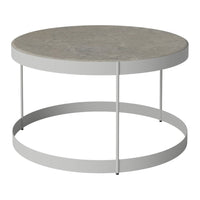 Round coffee table with a smooth gray top and sleek white metal legs, featuring a minimalist design.