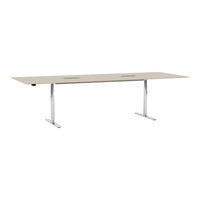 Light beige tabletop with sleek silver legs, featuring a minimalist design and two cable management cutouts.