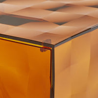 Amber geometric patterned resin cube with a glossy finish, showcasing rich warm tones.