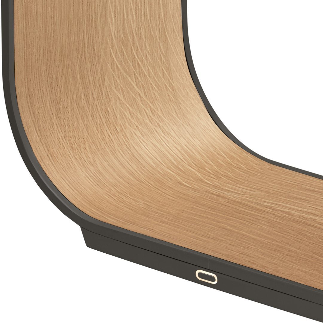 Curved wood grain pattern in light oak with a sleek black edge, highlighting a modern design aesthetic.