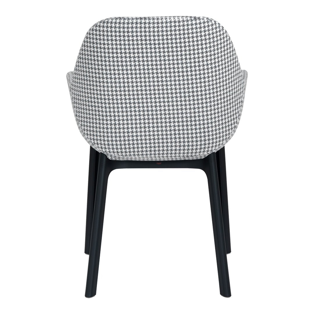 Back view of a chair featuring a black and white houndstooth pattern with sleek black legs.