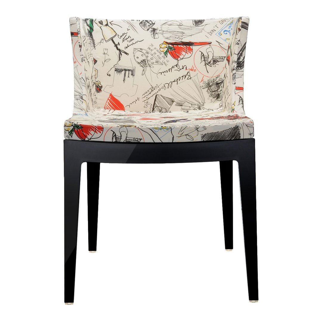 Cream fabric chair with abstract multicolor patterns and black wooden legs. Stylish and modern design for any space.