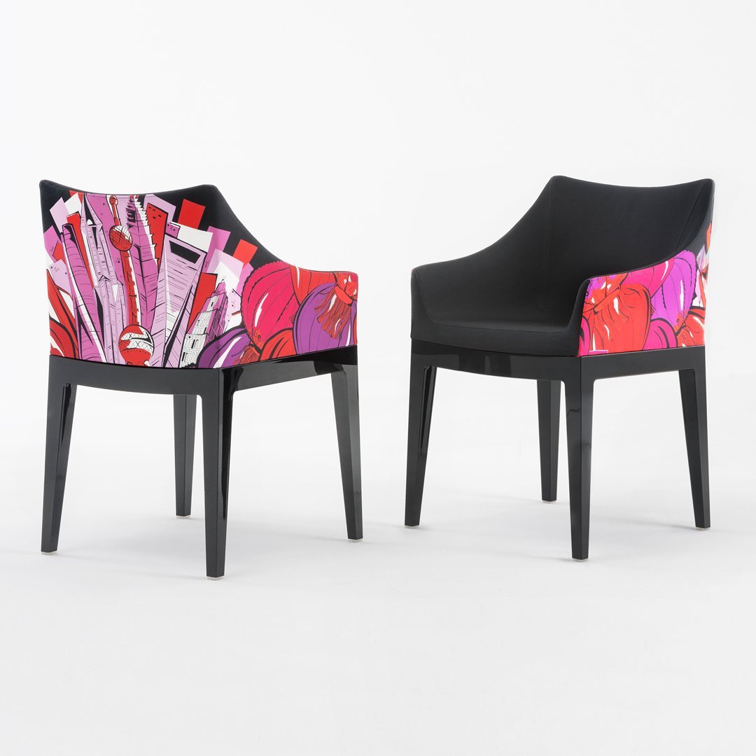 Colorful chair featuring a bold pink floral pattern on a sleek black frame, adding vibrant style to any space.