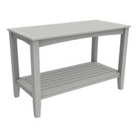 Gray slat-top outdoor table with a clean, modern design and sturdy legs, featuring a lower shelf for added storage.