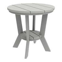Gray round side table with slatted top and sturdy cross-legged base. Clean, modern design perfect for any space.