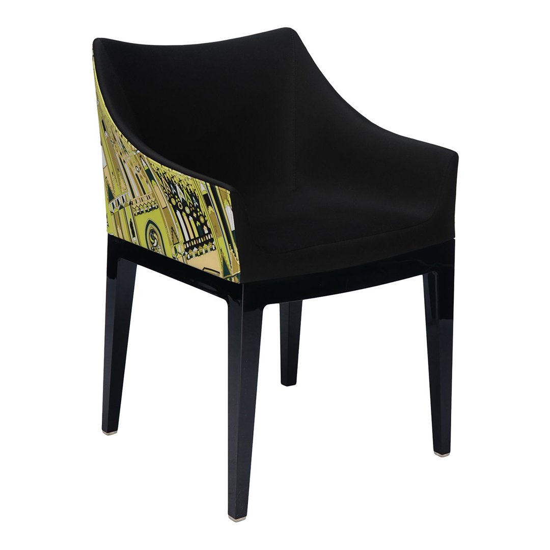 Black chair with a vibrant yellow patterned backrest featuring architectural designs. Modern and stylish accent piece.