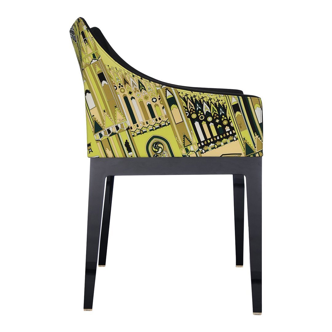 Stylish side view of a chair featuring vibrant yellow and black architectural patterns against a black frame.