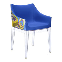 Bright blue chair with colorful geometric patterns on one side and transparent legs for a modern look.