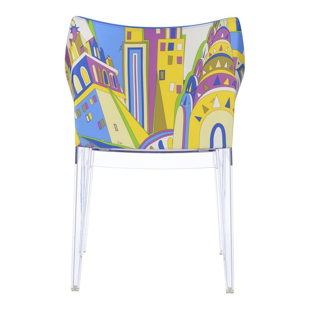 Colorful chair featuring vibrant blue, yellow, and bold abstract patterns inspired by cityscapes.
