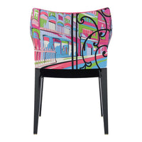 Colorful chair featuring vibrant pink, green, and blue patterns with intricate designs on the backrest.