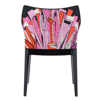 Vibrant pink and red geometric patterns on a chair with a sleek black frame. Unique modern design.