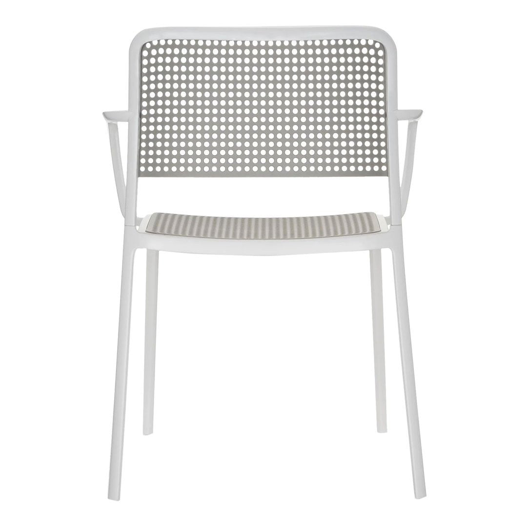 White chair with a perforated backrest and seat pattern, featuring minimalistic design in a sleek, modern style.