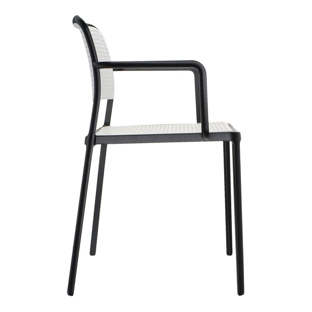 Black and white striped chair with a sleek design and perforated seat pattern, perfect for modern decor.
