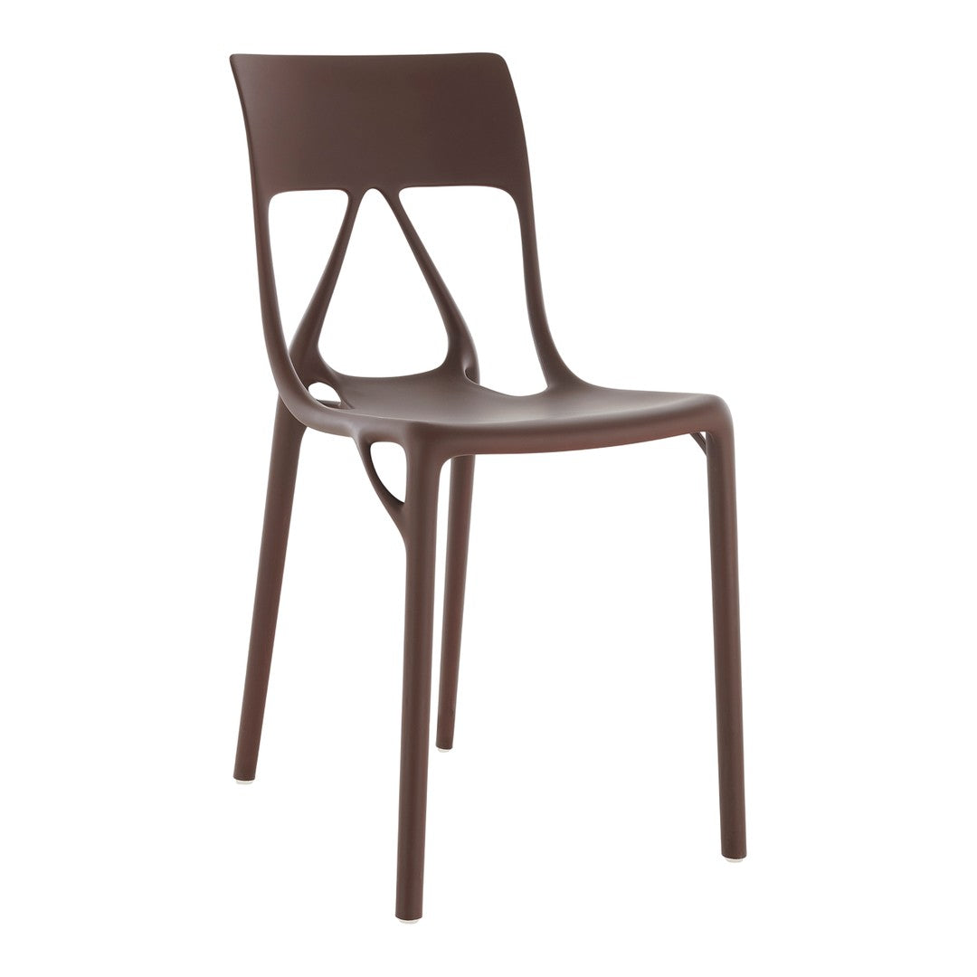 Brown plastic chair with a modern design, featuring a smooth finish and unique cut-out patterns. Minimalist style.