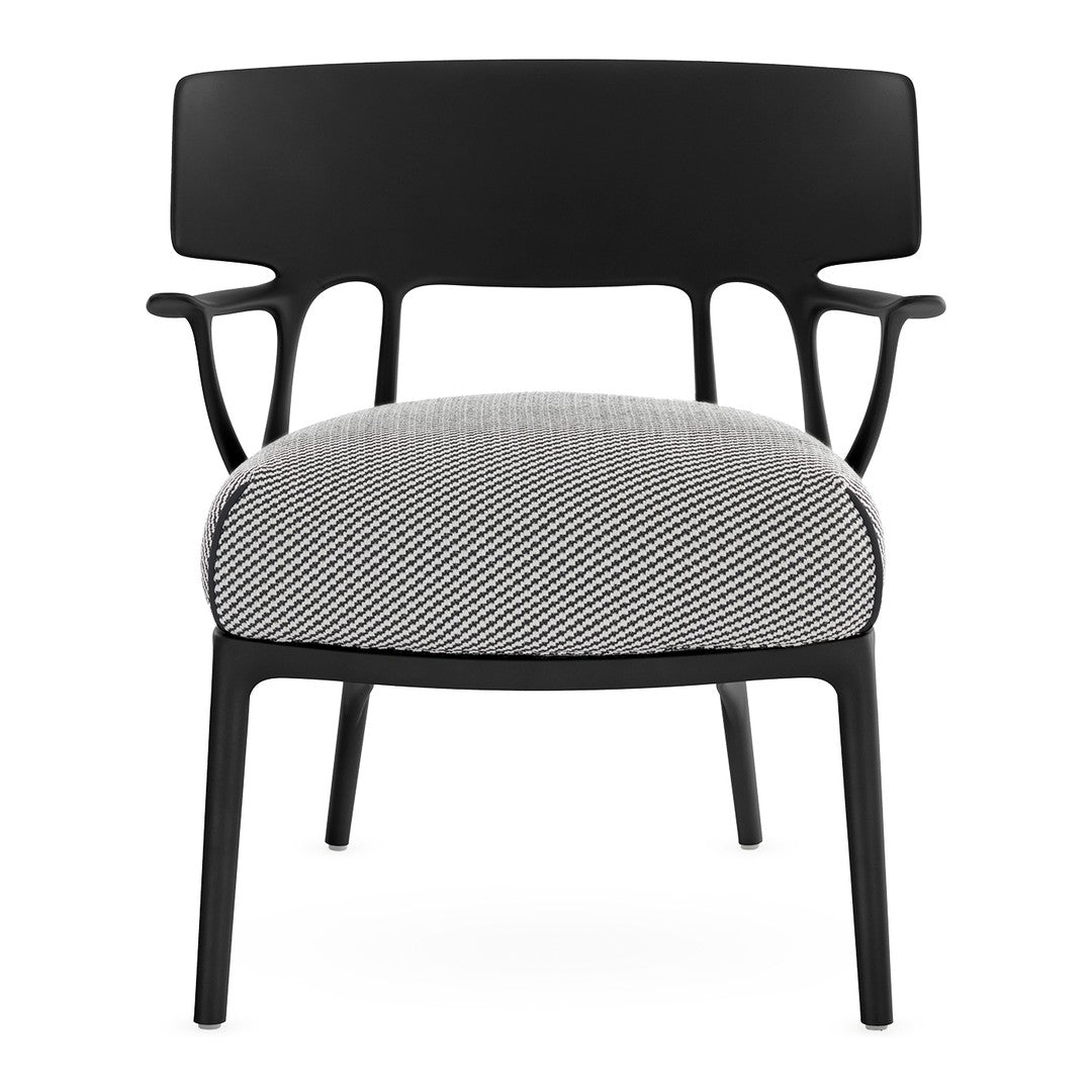 Black chair with a modern design featuring a textured black and white houndstooth pattern on the seat.