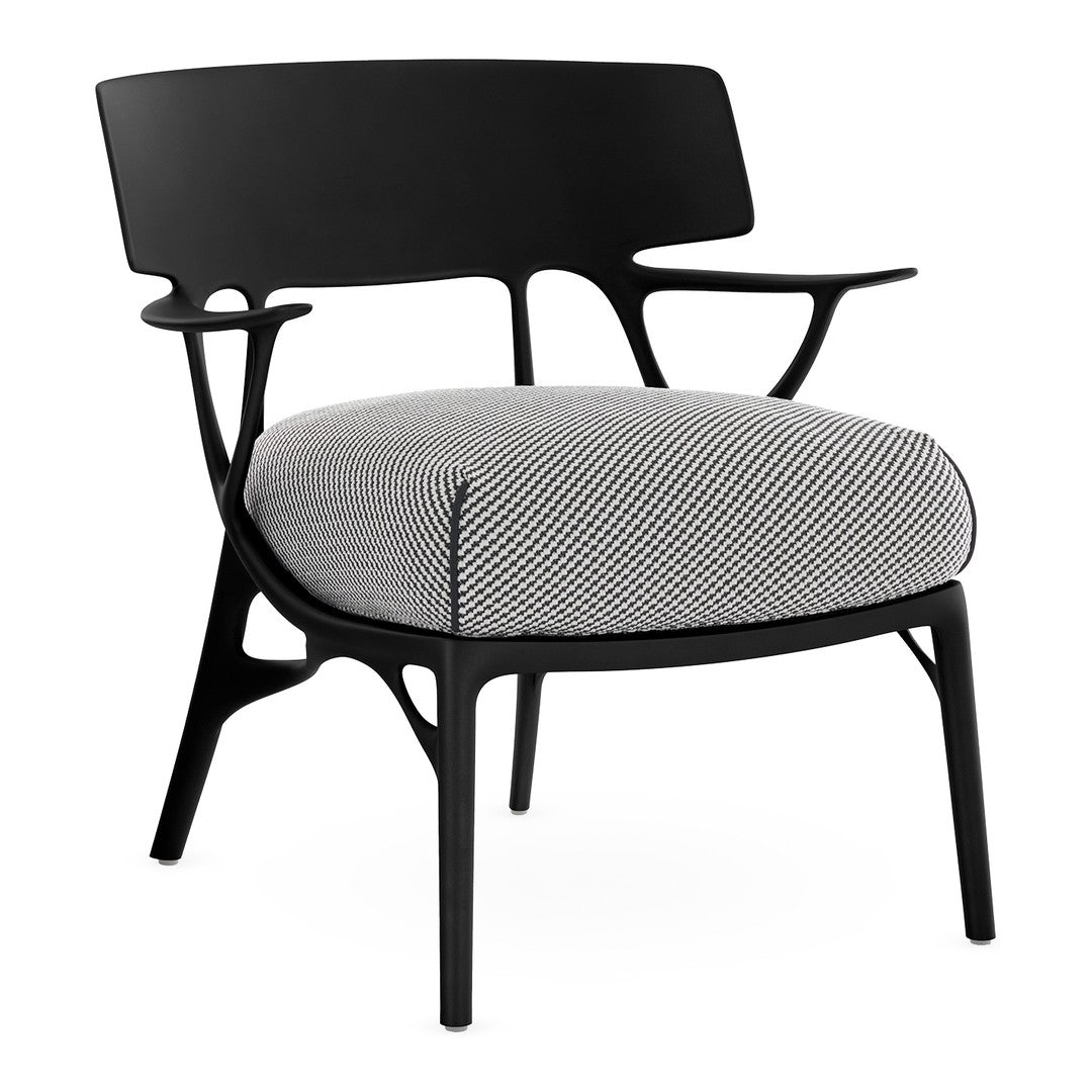 Black chair with a houndstooth patterned cushion in shades of gray and white. Stylish and modern design.