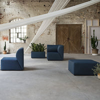 Modern blue seating set with geometric patterns, set against a rustic background with natural greenery.