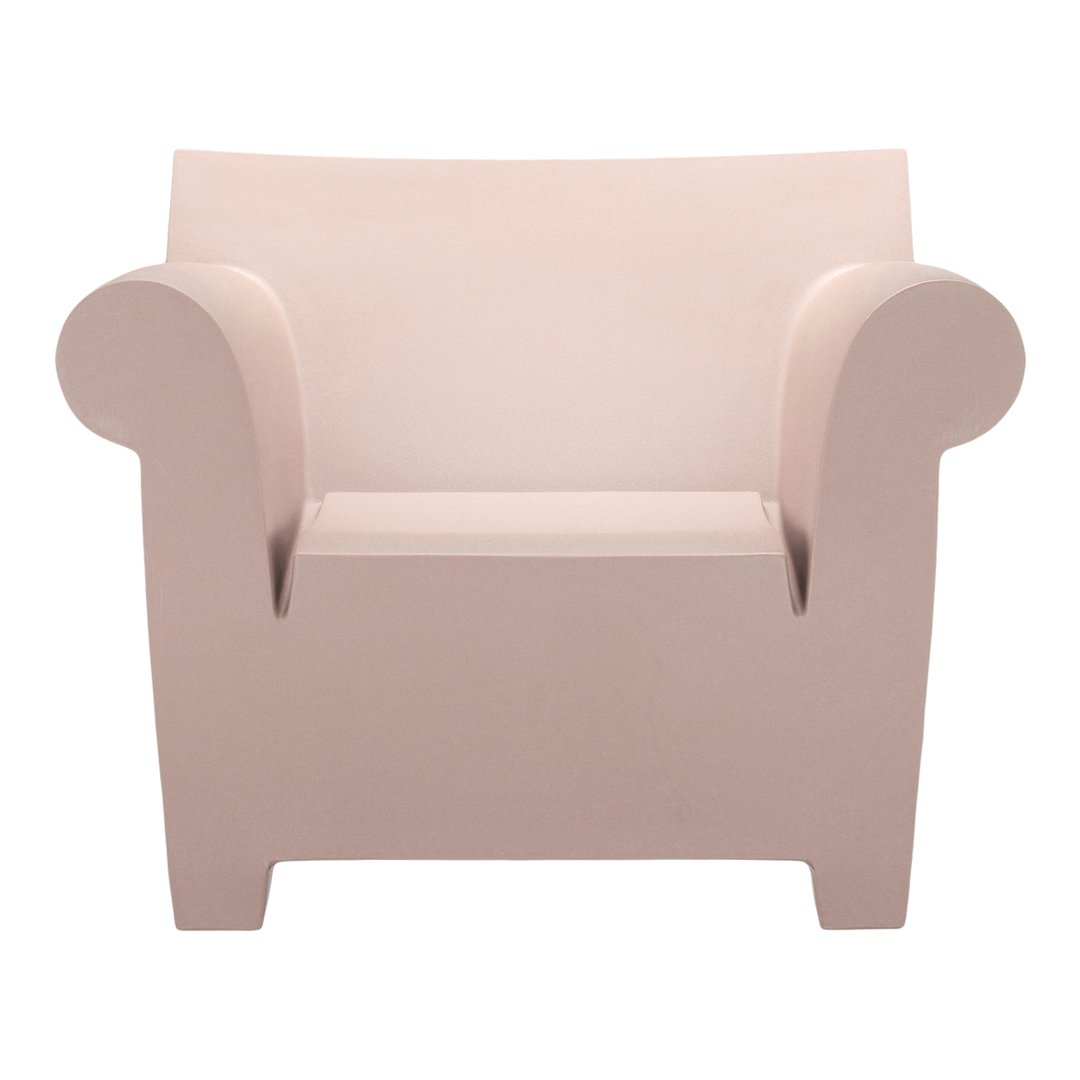 Light pink minimalist armchair with smooth, rounded edges and a contemporary design. Ideal for modern interiors.