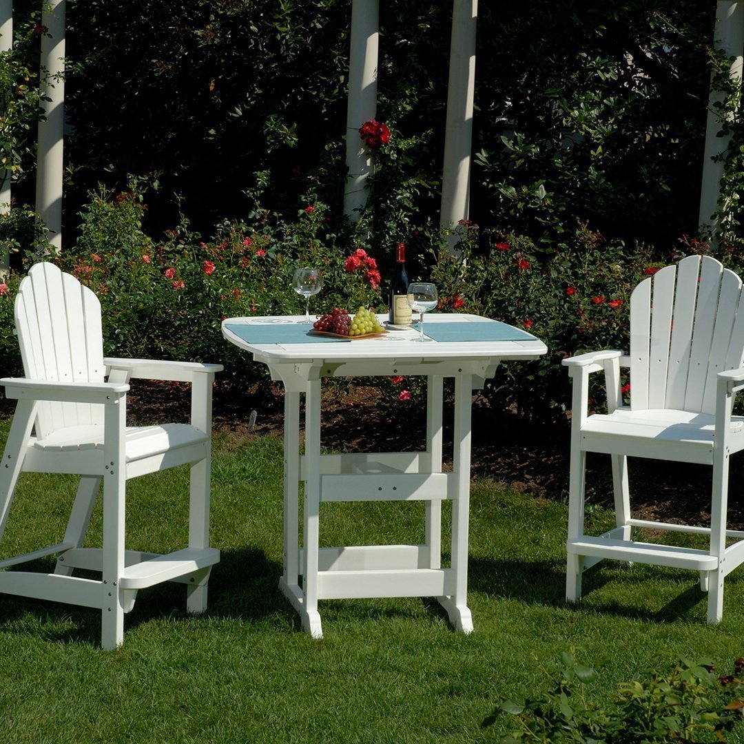 White outdoor bar set with slatted chairs and table, featuring a classic design on a lush green lawn.