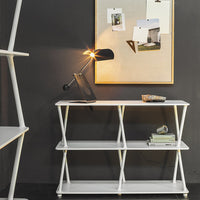 White modern console table with a sleek design, featuring clean lines against a dark wall, accented by a golden lamp.