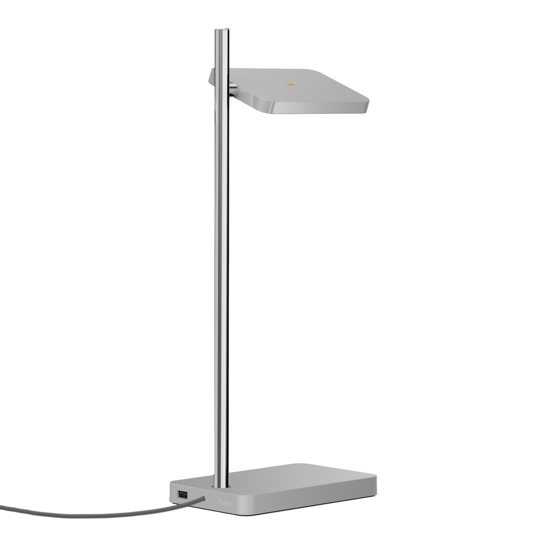Sleek silver floor lamp with a minimalist design and smooth, geometric lines on the lamp shade and base.