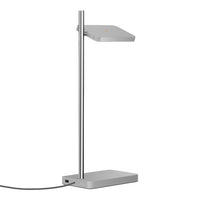 Sleek silver floor lamp with a minimalist design and smooth, geometric lines on the lamp shade and base.