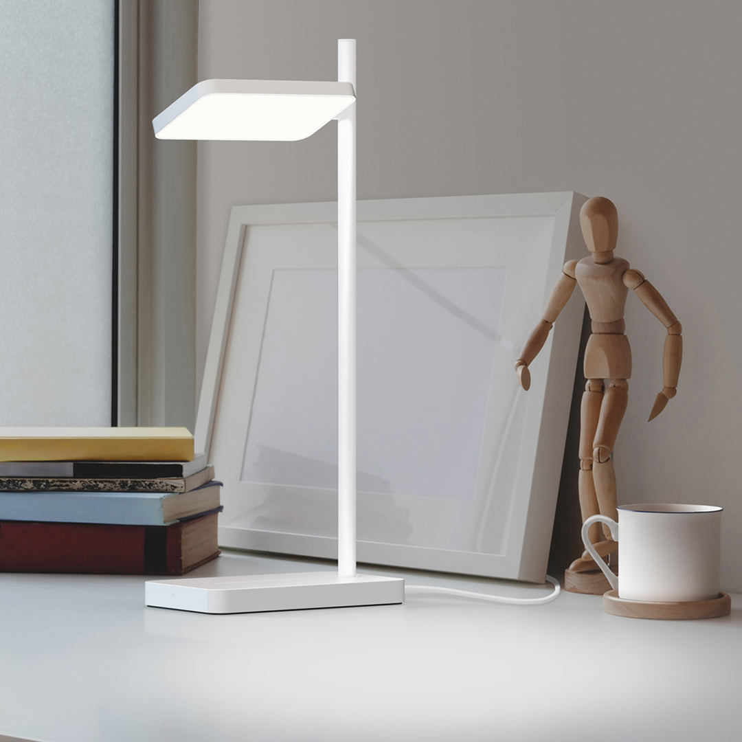 Modern white desk lamp with a sleek design, featuring a rectangular shade and a minimalist base.