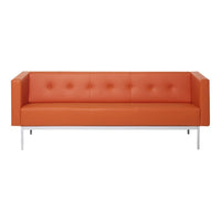 Modern orange leather sofa with button tufting and sleek chrome legs, perfect for contemporary living spaces.
