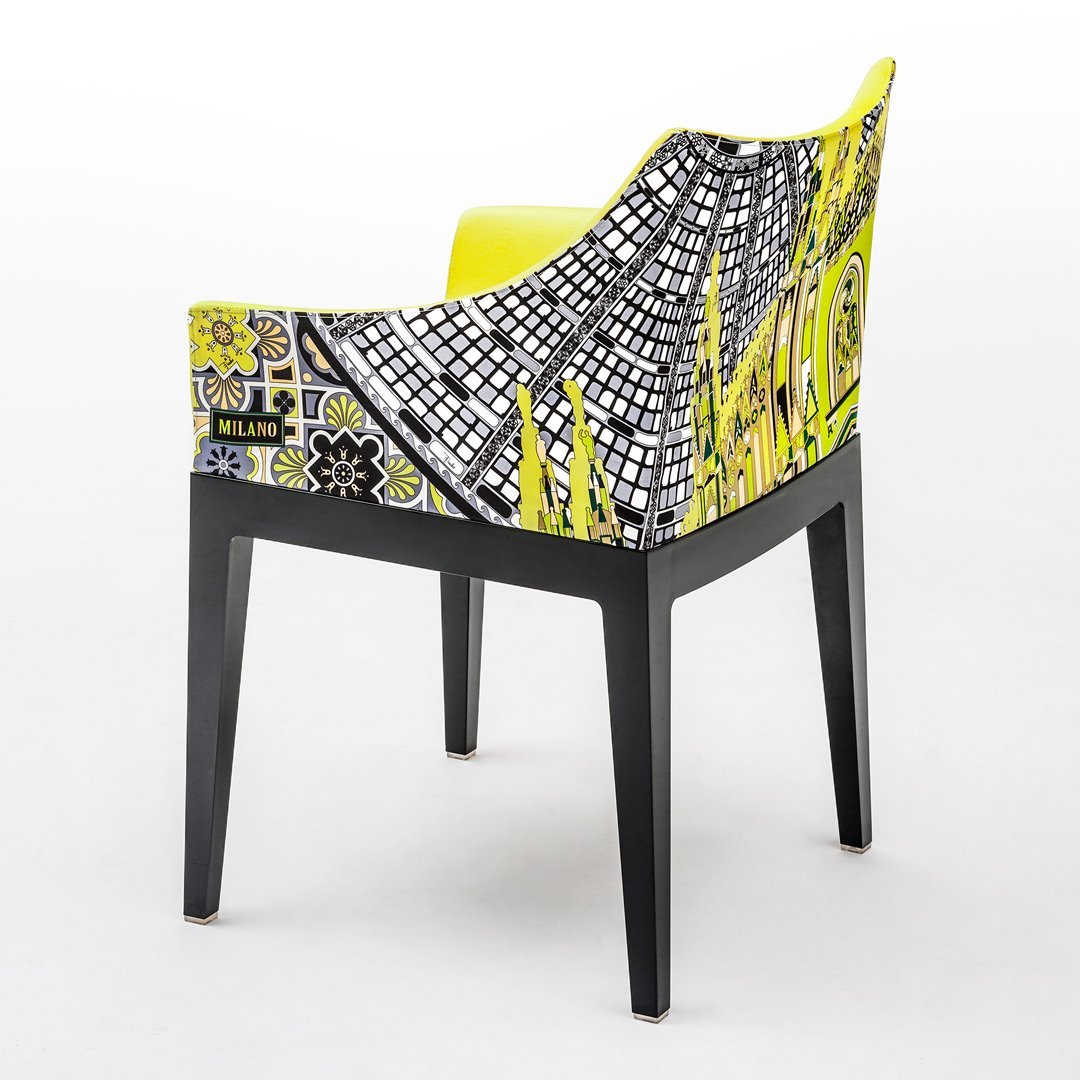 Colorful chair featuring a vibrant yellow seat and a bold black and white patterned back with floral designs.