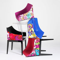 Colorful stacked chairs featuring vibrant patterns in pink, blue, black, and playful designs.
