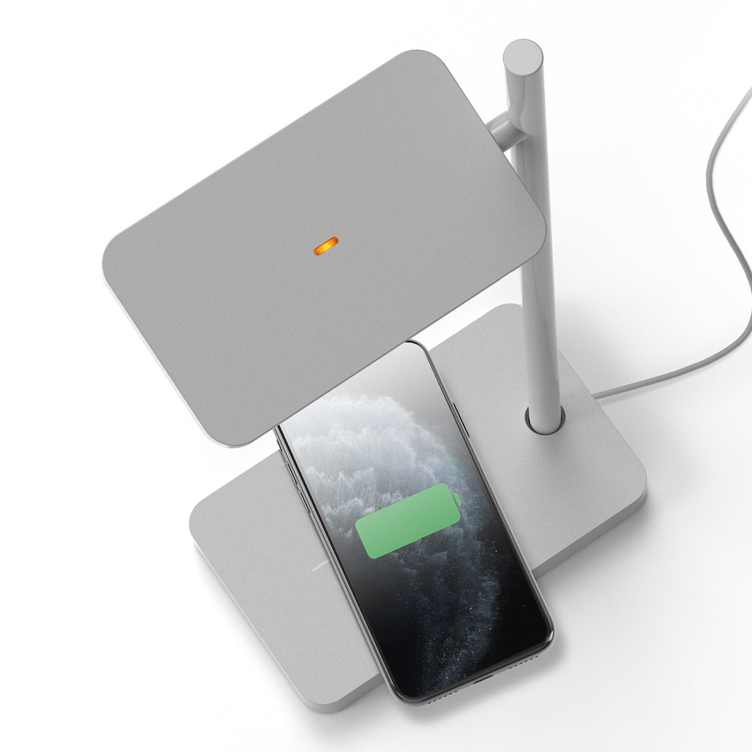 Sleek gray wireless charger with a modern design; features a flat surface and minimalist lines.