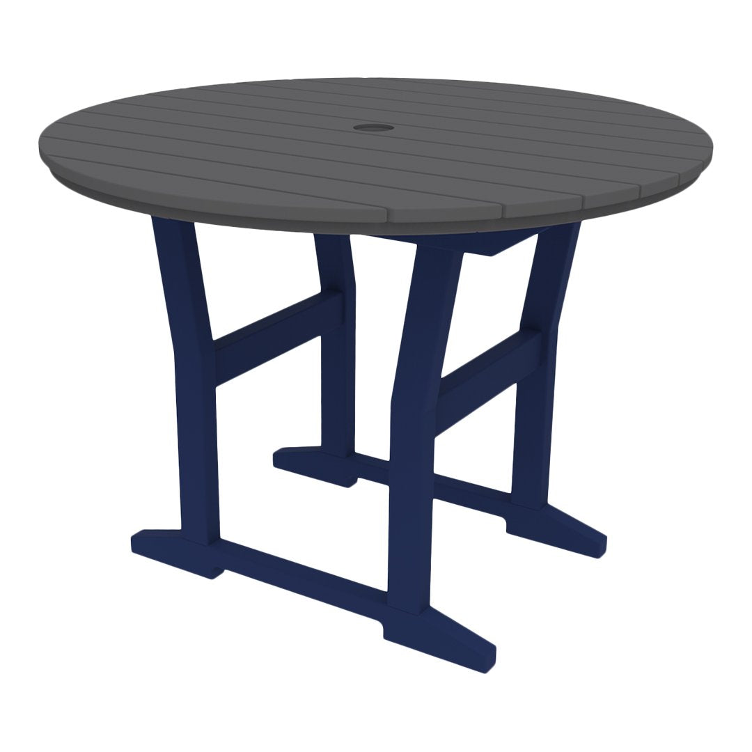 Round table with a gray top and navy blue legs, featuring a slatted design. Ideal for outdoor dining.